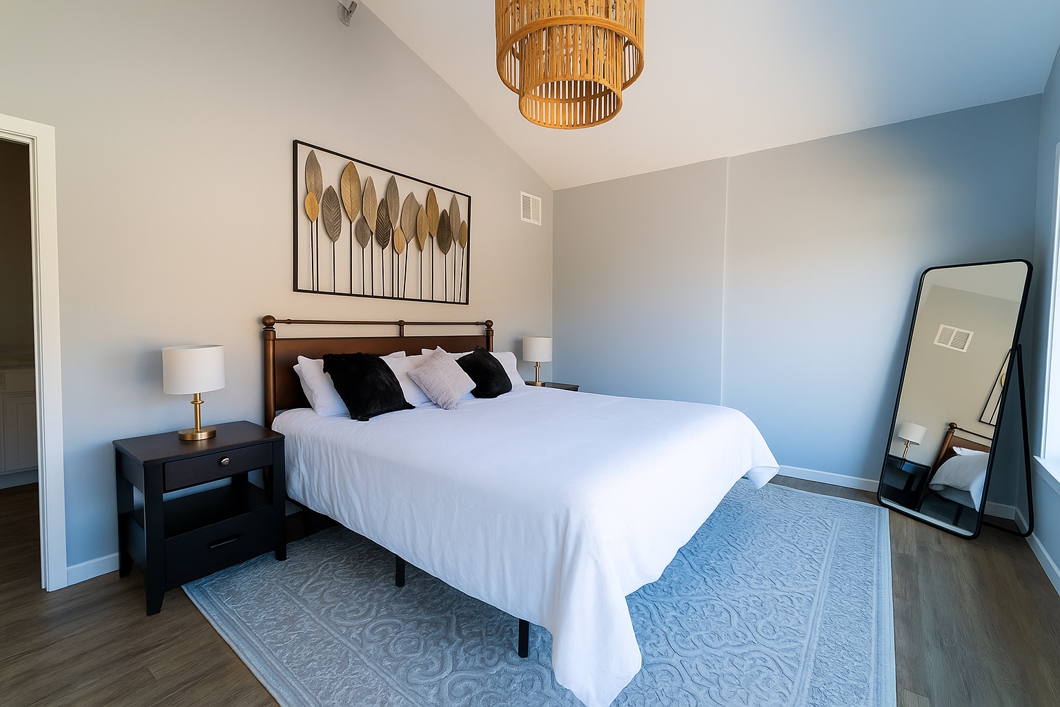 Light-filled bedroom with a blue accent wall